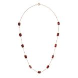 A GARNET NECKLACE in 18ct yellow gold, comprising a trace chain set with octagonal step cut garne...