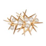 MIKIMOTO, AN AKOYA PEARL STARBURST BROOCH in 14ct yellow gold, the abstract brooch set with seven...