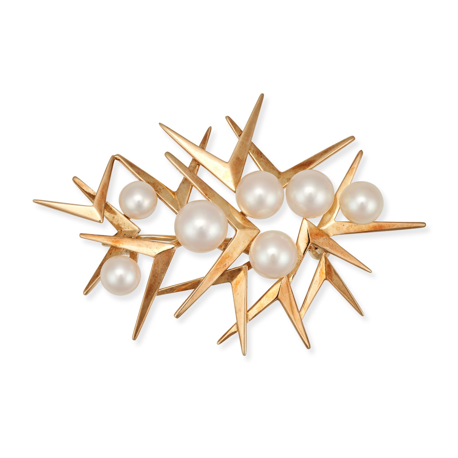 MIKIMOTO, AN AKOYA PEARL STARBURST BROOCH in 14ct yellow gold, the abstract brooch set with seven...