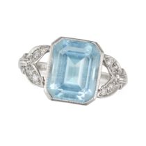 AN AQUAMARINE AND DIAMOND RING in platinum, set with an octagonal step cut aquamarine, the stylis...