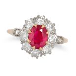 A RUBY AND DIAMOND CLUSTER RING in rose gold, set with an oval cut ruby of approximately 1.30 car...