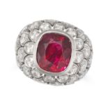 A BURMA NO HEAT RUBY AND DIAMOND RING in white gold, set with a cushion cut ruby of approximately...