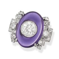 A FINE ART DECO AMETHYST AND DIAMOND RING in platinum, set with an oval cabochon amethyst inlaid ...