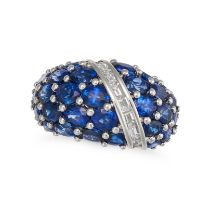 A SAPPHIRE AND DIAMOND RING in platinum, the bombe ring set with oval cut sapphires and accented ...
