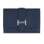 HERMES NAVY BLUE MINI H WALLET Condition grade B-. 10cm long, 7cm high. Navy blue toned leather...