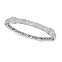 A DIAMOND BANGLE in 18ct white gold, the hinged bangle set with baguette and round brilliant cut ...