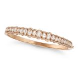 A DIAMOND BANGLE in rose gold, the hinged bangle set with a row of rose cut diamonds in a border ...