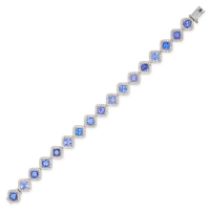 A TANZANITE AND DIAMOND BRACELET in 18ct white gold, comprising a row of cushion cut tanzanites i...