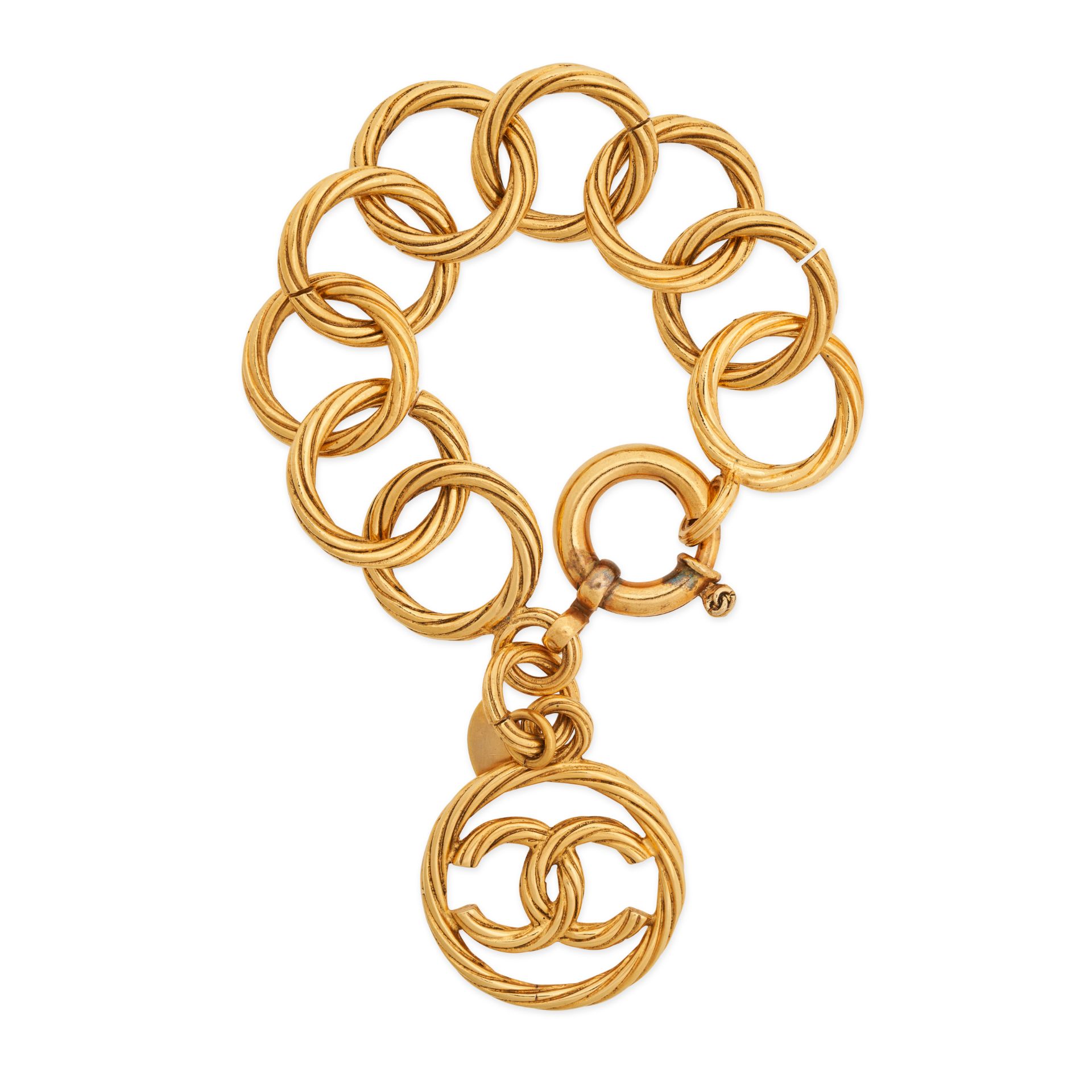 CHANEL, A VINTAGE CIRCLE LINK CHARM BRACELET in 24ct gold plated metal, comprising textured inter...