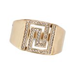 A GEMSET DRESS RING in 14ct yellow gold, the Greek stylised face set with white gemstones, stampe...