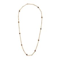 A BEADED NECKLACE in yellow gold, tigers eye beads integrating, clasp stamped 9CT, 66.0cm, 25.8g.