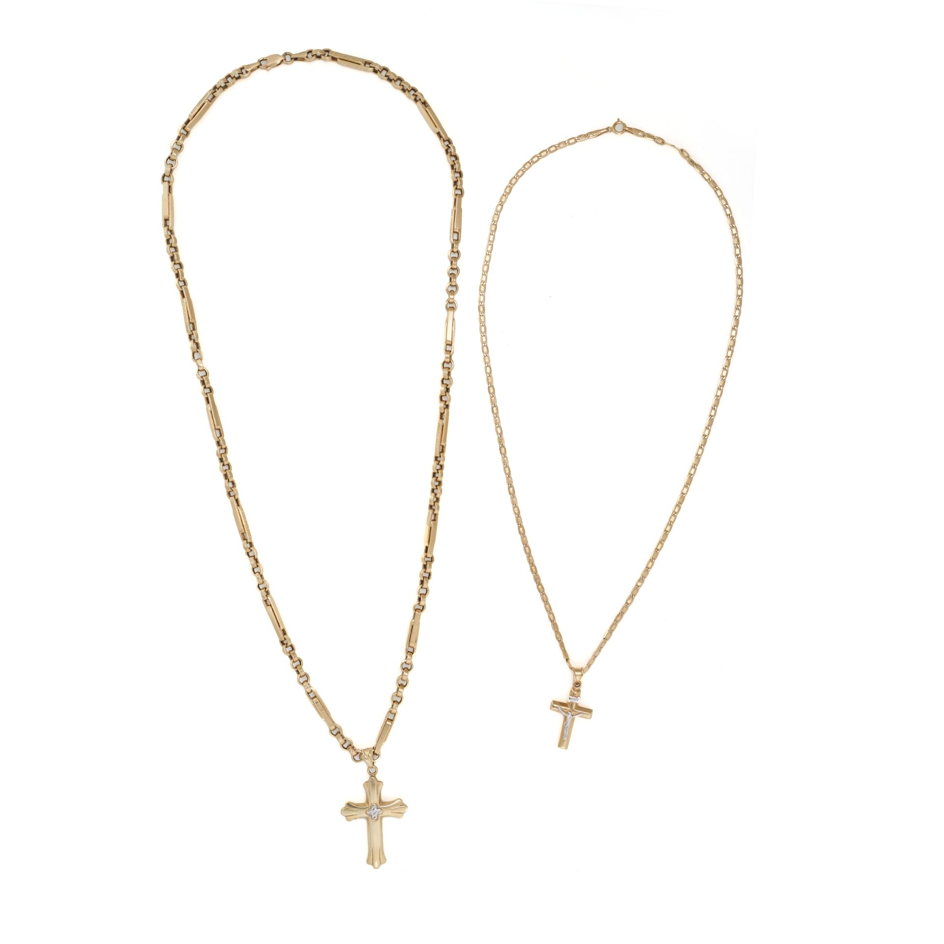 TWO GOLD CRUCIFIX PENDANTS AND CHAINS in 14ct yellow gold, both bails stamped 14K, one clasp stam...