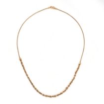 A GOLD CHAIN NECKLACE in 21ct gold, half the necklace designed as a twisted white and yellow gold...