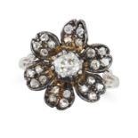 A DIAMOND FLOWER RING designed as a flower set with an old cut diamond accented by rose cut diamo...