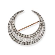 AN ANTIQUE DIAMOND CRESCENT MOON BROOCH in yellow gold and silver, designed as a crescent moon se...