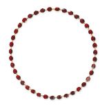 A GARNET RIVIERE NECKLACE comprising a row of oval and cushion cut garnets, stamped 9KT, 42.0cm, ...