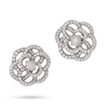 A PAIR OF DIAMOND FLOWER EARRINGS each designed as a stylised openwork flower set with round bril...