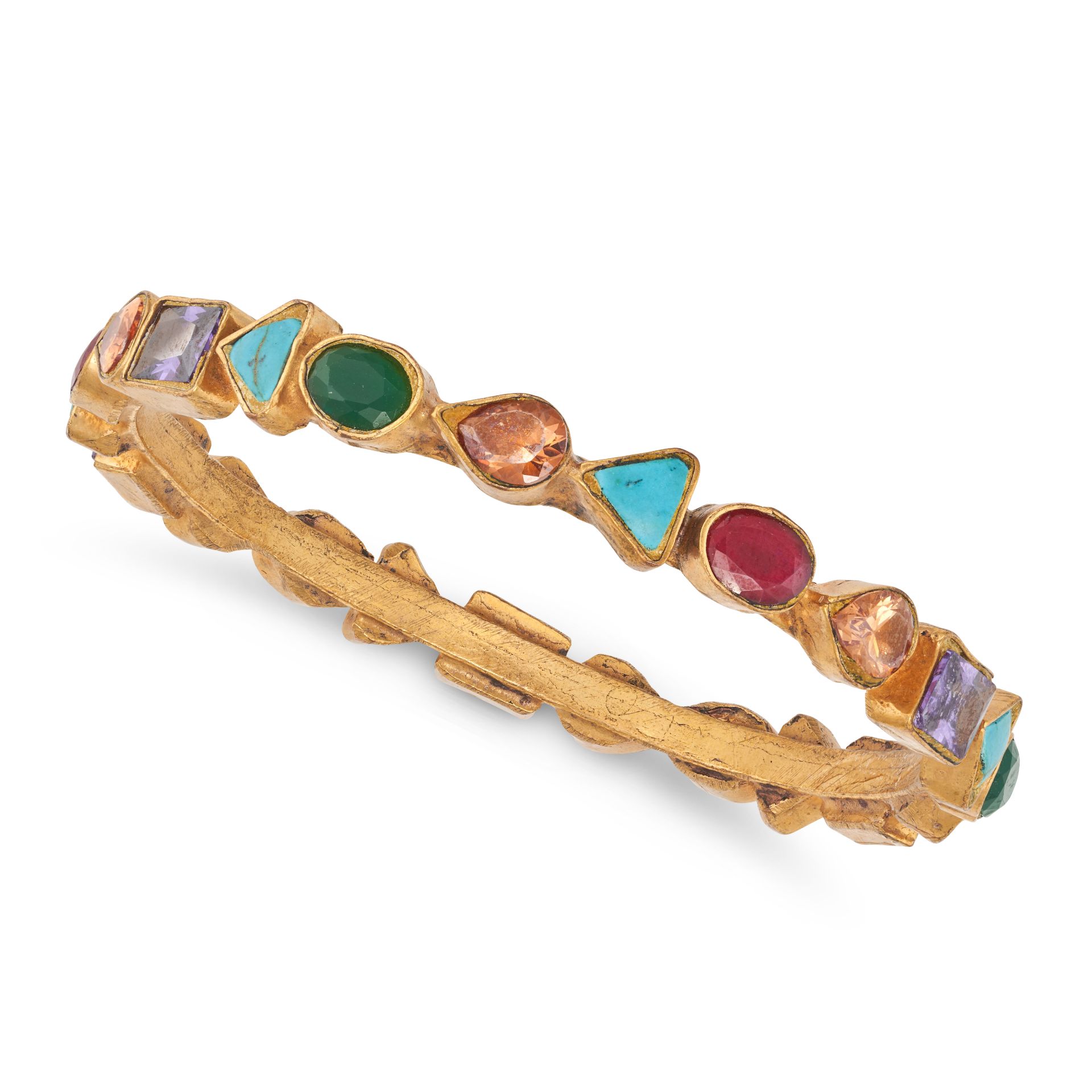 NO RESERVE - A GEMSET BANGLE set all around with variously cut synthetic rubies, coloured paste s...