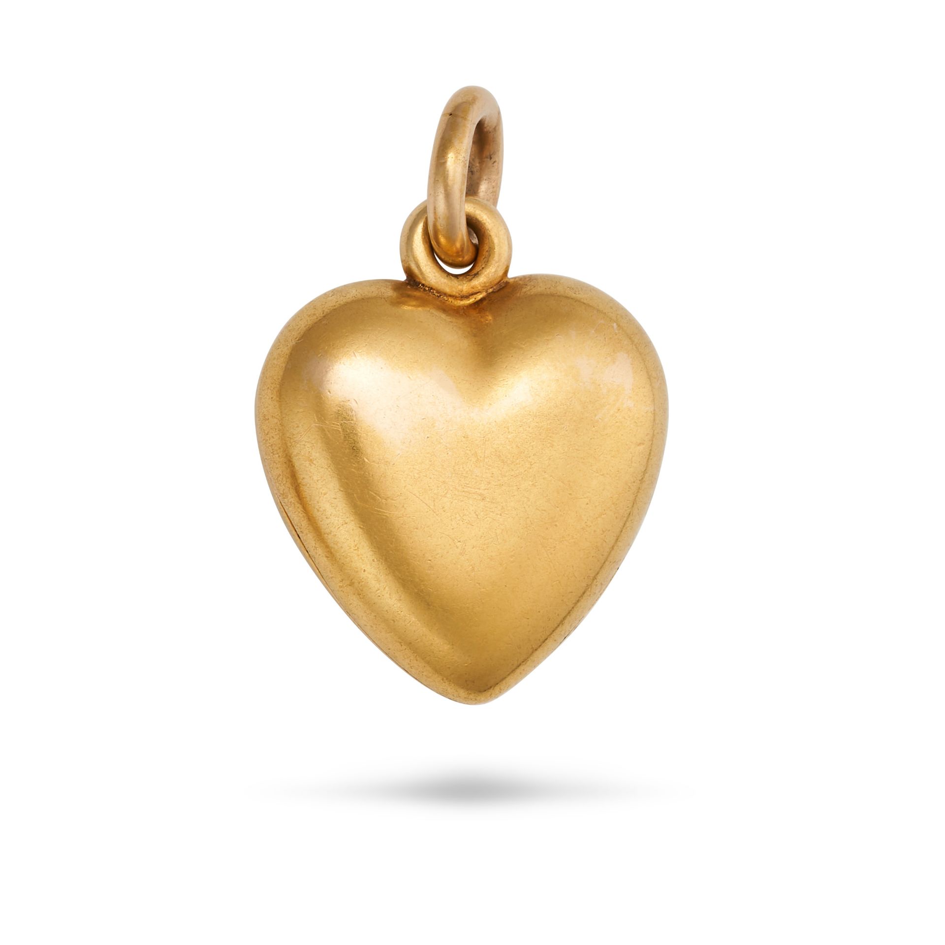 AN ANTIQUE HEART LOCKET PENDANT in yellow gold, designed as a heart, opening to reveal a locket c...