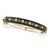 AN EMERALD, DIAMOND AND ENAMEL BANGLE in 14ct yellow gold, the hinged bangle set with a row of al...