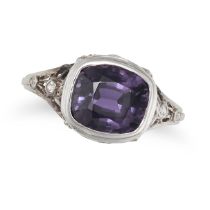 AN ART DECO PURPLE SPINEL AND DIAMOND RING in platinum and white gold, set with a cushion cut pur...