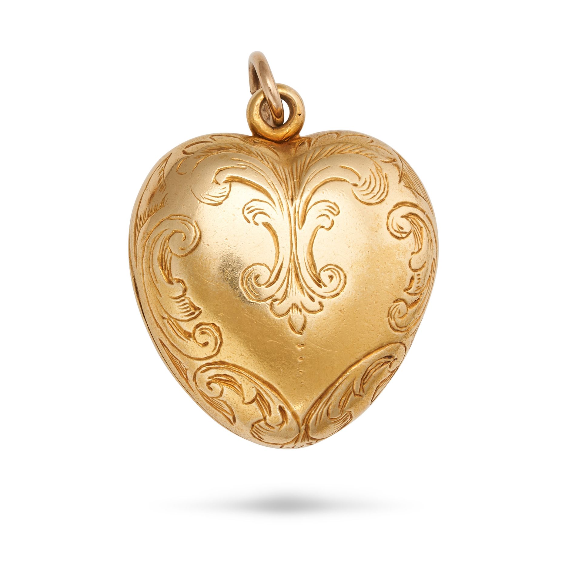 AN ANTIQUE HEART LOCKET PENDANT in yellow gold, designed as a heart engraved with foliate design,...