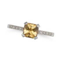 A YELLOW SAPPHIRE AND DIAMOND RING in 18ct white gold, set with an octagonal step cut yellow sapp...