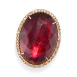 A RUBELLITE TOURMALINE AND DIAMOND DRESS RING set with a faceted-top oval cut rubellite tourmalin...