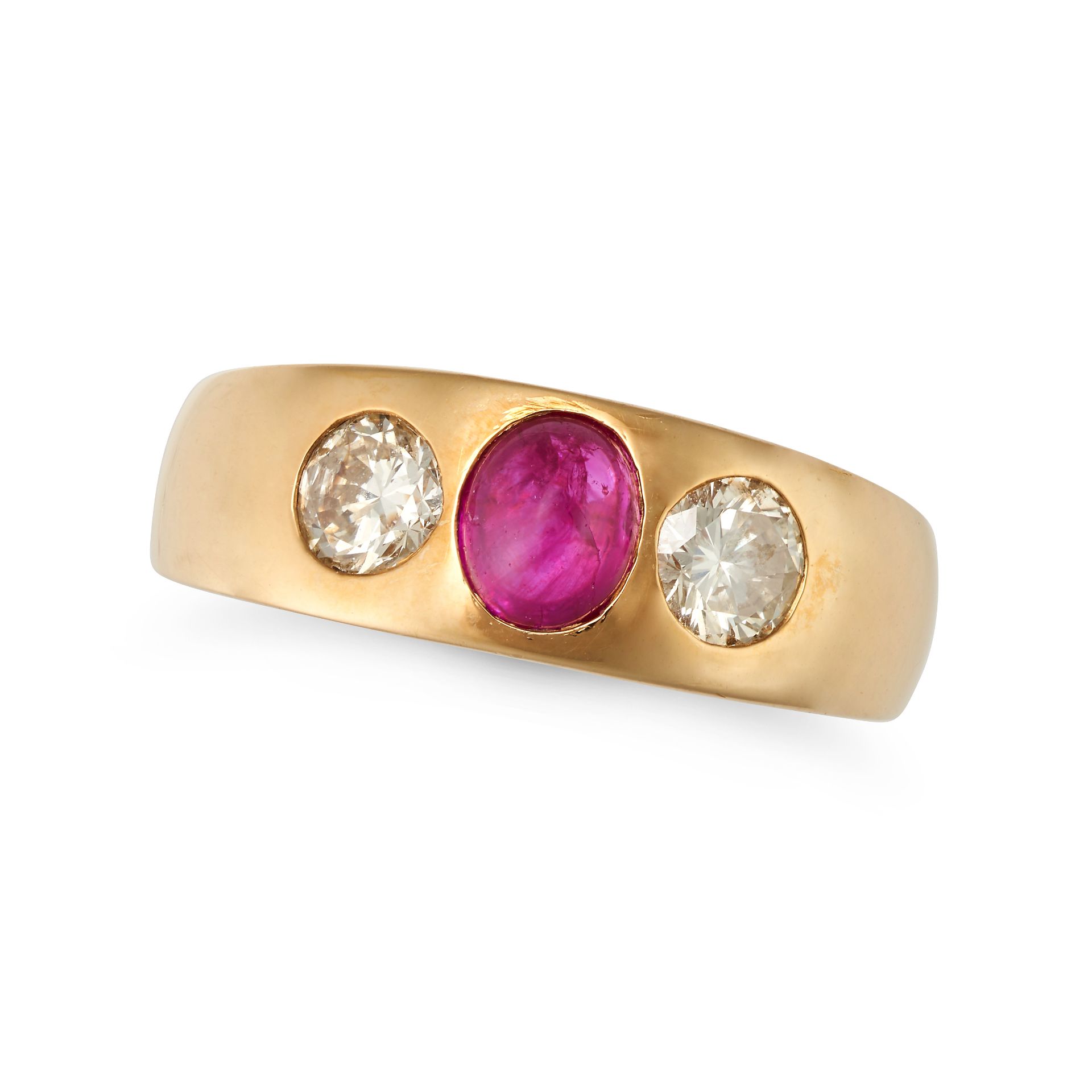 A RUBY AND DIAMOND GYPSY RING set with an oval cut ruby accented on each side by a round brillian...