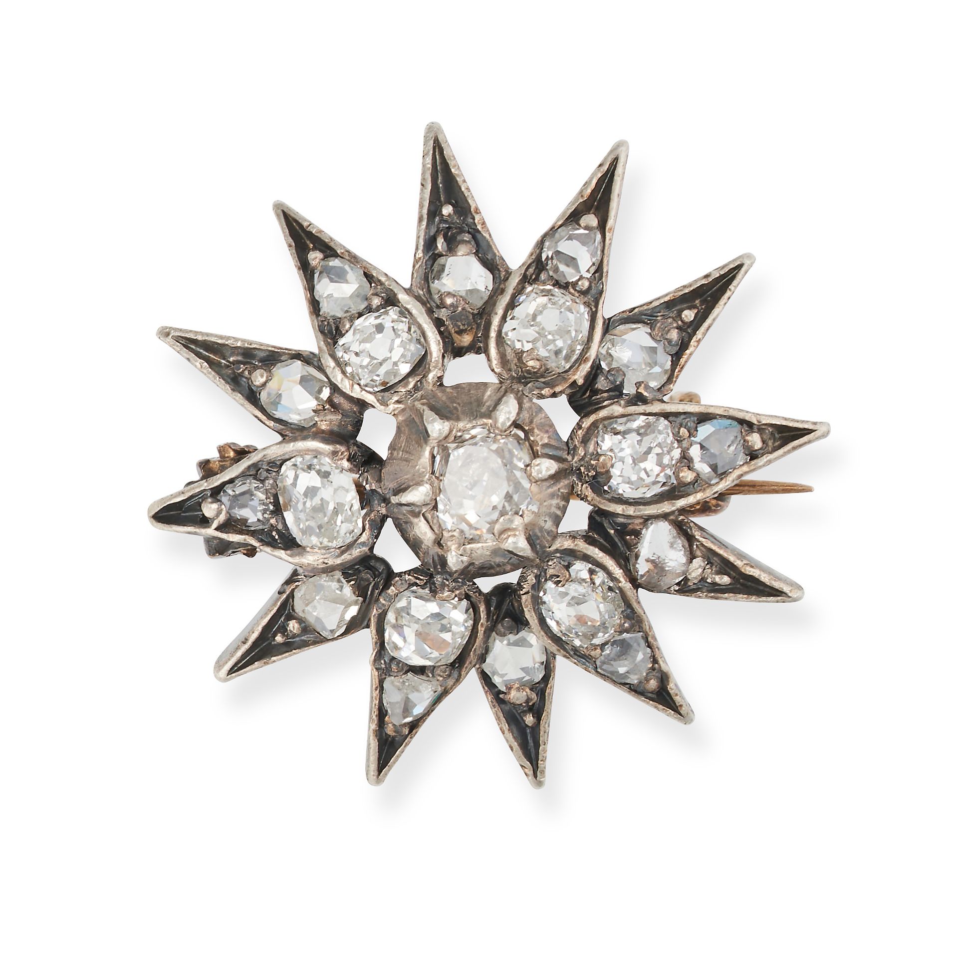 AN ANTIQUE DIAMOND STAR BROOCH in yellow gold and silver, designed as a twelve rayed star set wit...