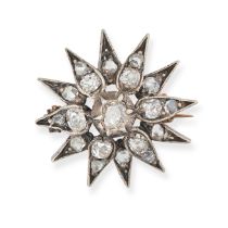 AN ANTIQUE DIAMOND STAR BROOCH in yellow gold and silver, designed as a twelve rayed star set wit...