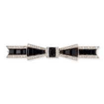 AN ONYX AND DIAMOND BOW BROOCH designed as a bow set with calibre cut onyx accented by rose cut d...