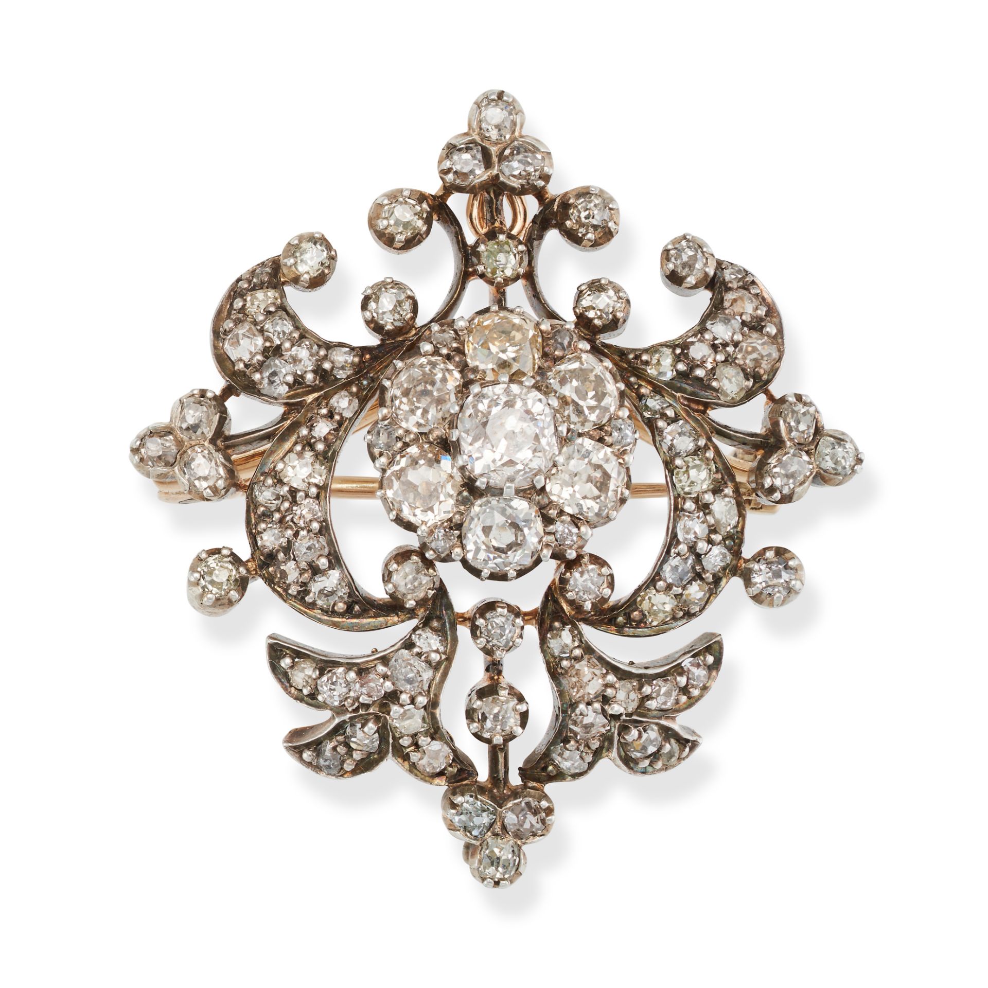 AN ANTIQUE DIAMOND BROOCH / PENDANT in yellow gold and silver, the foliate style brooch set with ...