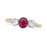A RUBY AND DIAMOND THREE STONE RING set with a round cut ruby accented on each side by a round br...