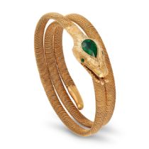 AN ANTIQUE TSAVORITE GARNET SNAKE BANGLE in yellow gold, designed as a coiled snake, the head set...