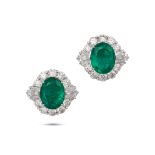 A PAIR OF EMERALD AND DIAMOND CLUSTER EARRINGS each set with an oval cut emerald in a cluster of ...