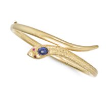 A DUTCH SAPPHIRE AND RUBY SNAKE BANGLE in 14ct yellow gold, the hinged bangle designed as a coile...