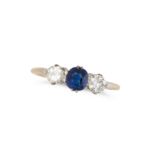 A SAPPHIRE AND DIAMOND THREE STONE RING set with a cushion cut sapphire between two round brillia...