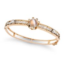 AN ANTIQUE MOONSTONE AND DIAMOND BANGLE in yellow gold, the hinged bangle set with a round caboch...