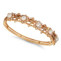 AN ANTIQUE NATURAL SALTWATER PEARL AND DIAMOND BANGLE in yellow gold, the hinged bangle in foliat...