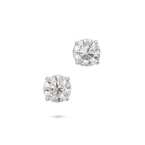 A PAIR OF DIAMOND STUD EARRINGS each set with a round brilliant cut diamond, the diamonds both to...