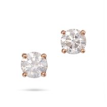 A PAIR OF DIAMOND STUD EARRINGS each set with a round brilliant cut diamond, the diamonds both to...