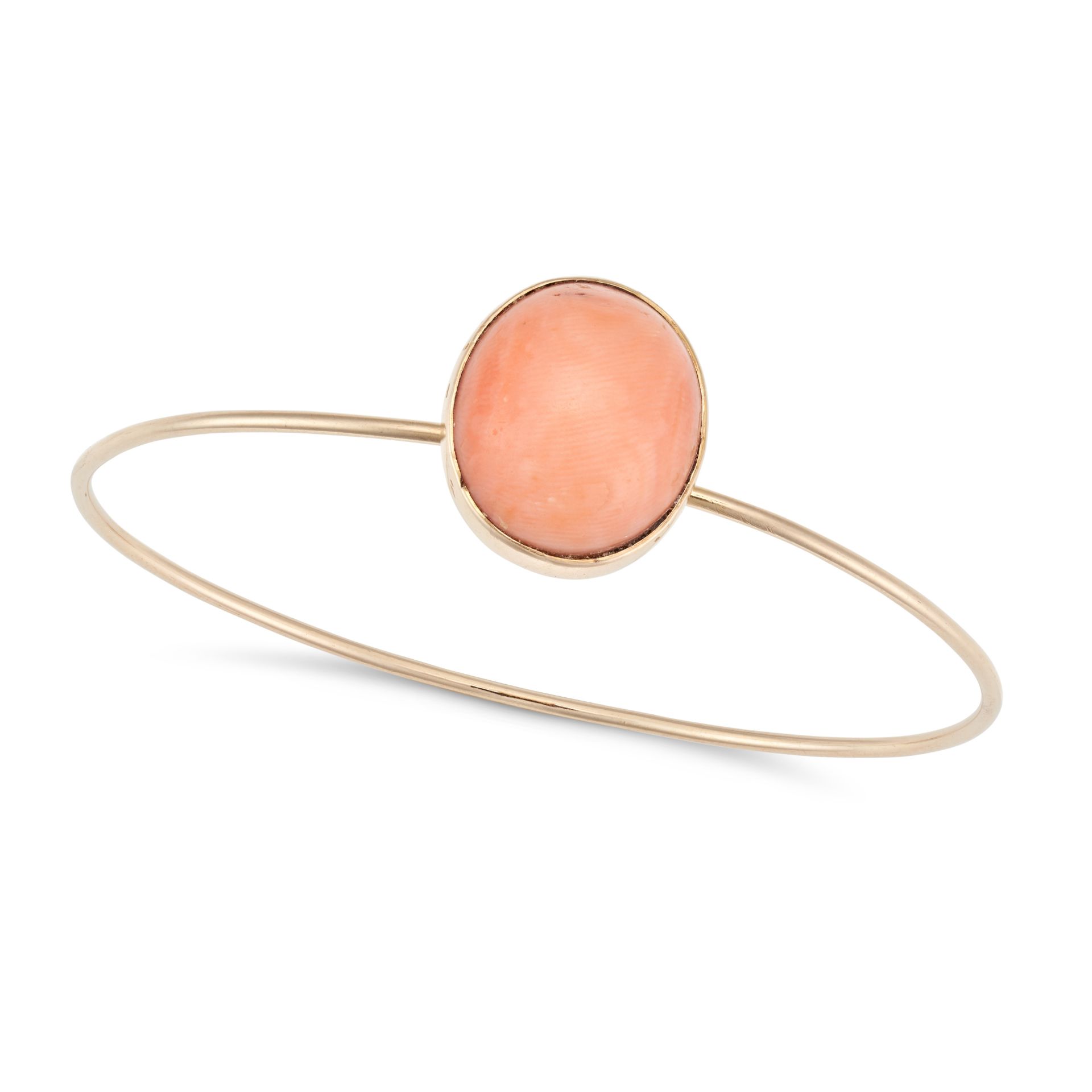 NO RESERVE - A CORAL BANGLE set with an oval cabochon coral, no assay marks, inner circumference ...