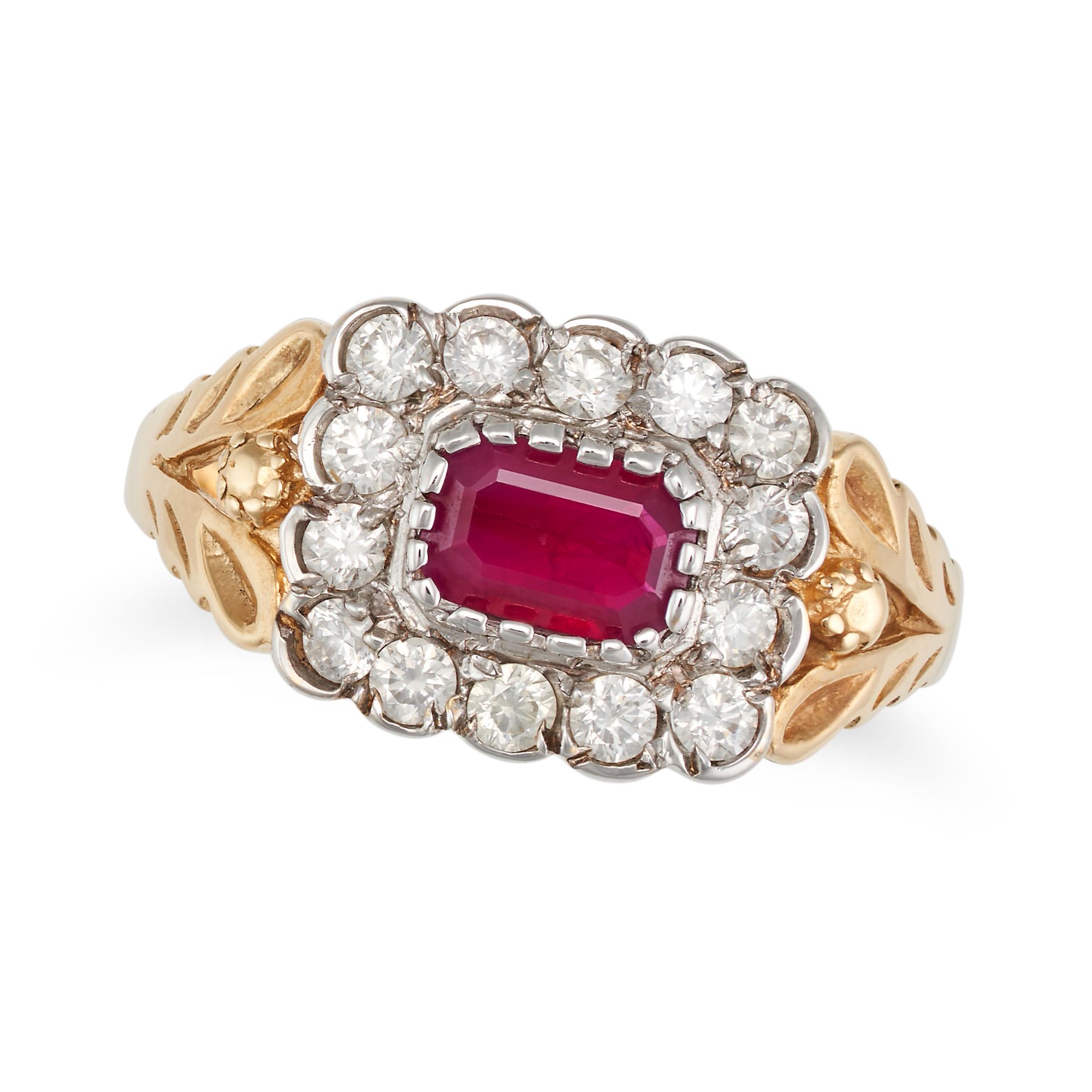 A RUBY AND DIAMOND CLUSTER RING in 18ct yellow and white gold, set with a cushion cut ruby in a c...