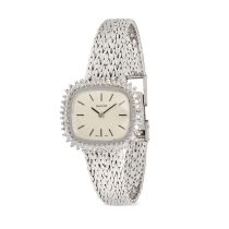 BAYLOR, A VINTAGE DIAMOND WRISTWATCH in 9ct white gold, the rounded rectangular silvered dial wit...