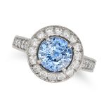 A SAPPHIRE AND DIAMOND HALO RING in platinum, set with a round cut sapphire of approximately 1.80...
