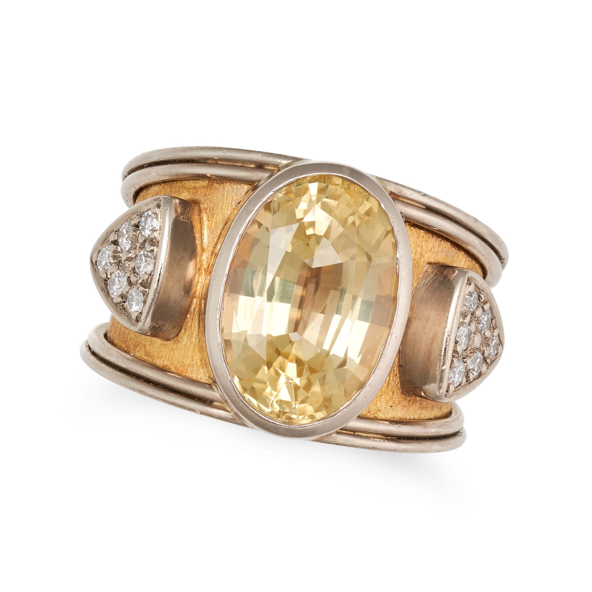A YELLOW SAPPHIRE AND DIAMOND RING in 18ct yellow and white gold, the tapering band set with an o...