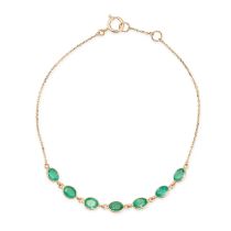 AN EMERALD BRACELET comprising a row of seven oval cut emeralds on a trace chain, stamped 750, 19...