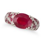 A RUBY AND DIAMOND DRESS RING set with an oval cut ruby of approximately 3.00 carats, the band pa...