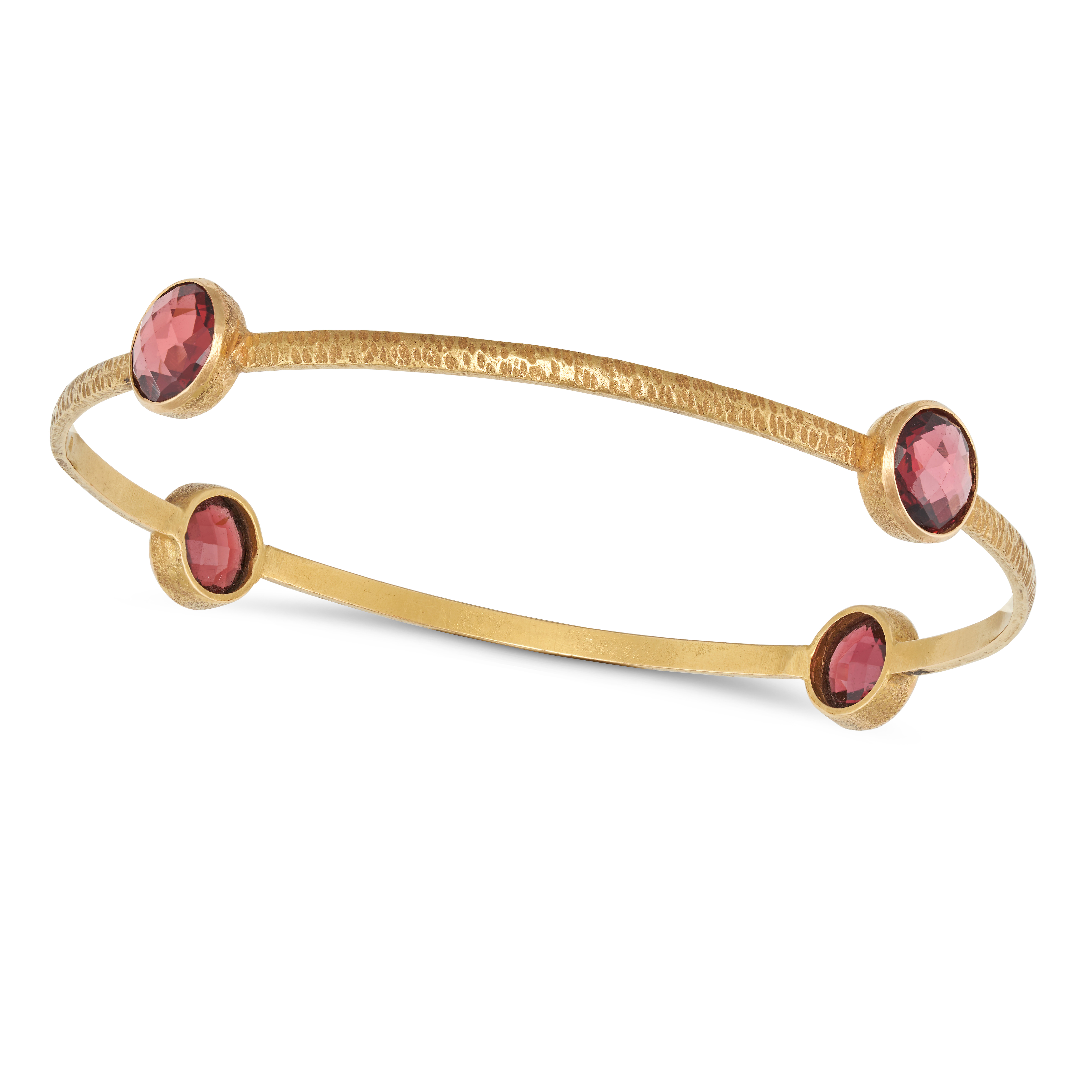 A PINK TOURMALINE BANGLE in 18ct yellow gold, the hammered gold bangle set with four fancy cut pi...